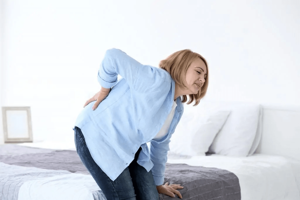 Woman Experiencing Low Back Pain B cure Laser